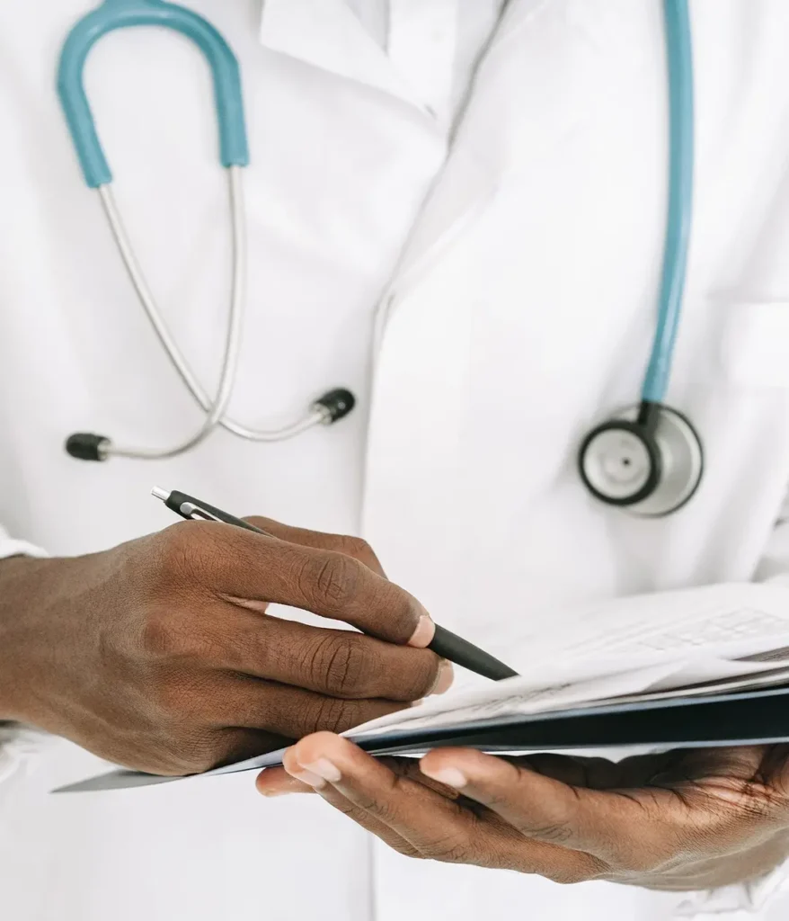 doctor writing somethig on notepad